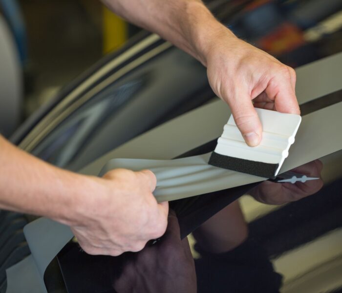 Car,Wrapper,Straightening,Wrapping,Foil,With,A,Squeegee,To,Remove